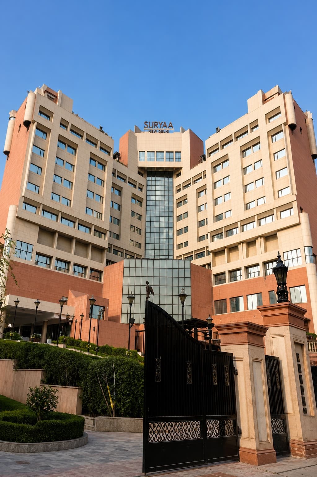 The Suryaa New Delhi — the hotel's sandstone facade and gated entrance on MMA Road